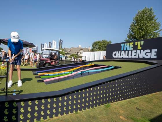 BOLINGBROOK, IL - AUGUST 09: A young fan putts The ˜L™ Challenge in the fan village during day two of LIV Golf Chicago on Saturday, August 09, 2025 at Bolingbrook Golf Club in Bolingbrook, IL. (Photo by Joseph Weiser Icon Sportswire) GOLF: AUG 09 LIV Golf Chicago EDITORIAL USE ONLY Icon250809042