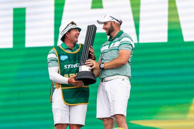 BOLINGBROOK, IL - AUGUST 10: Dean Burmester and his caddy Jason Reynolds celebrate winning the LIV Golf Chicago individual championship onstage after the final round of LIV Golf Chicago on Sunday, August 10, 2025 at Bolingbrook Golf Club in Bolingbrook, IL (Photo by Ben Hsu Icon Sportswire) GOLF: AUG 10 LIV Golf Chicago EDITORIAL USE ONLY Icon224250810075