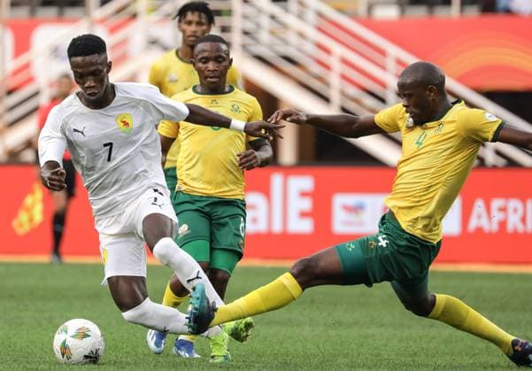 (250812) -- KAMPALA, Aug. 12, 2025 -- Kwandakwensizwa Mngonyama (1st R) of South Africa fouls Aboubacar Bangoura (2nd L) of Guinea during the Group C football match between South Africa and Guinea at the African Nations Championship (CHAN) 2024 at Mandela National Stadium in Kampala, capital of Uganda, on Aug. 11, 2025. (Photo by Xinhua) (SP)UGANDA-KAMPALA-CHAN 2024-GROUP C-SOUTH AFRICA VS GUINEA HajarahxNalwadda 