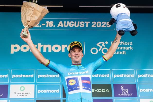 August 13, 2025, Gladsaxe, Denmark: Mads Pedersen of Denmark and Lidl - Trek celebrates on the podium with the blue leader s jersey after 2 stage of PostNord Danmark Rundt 2025. The second stage of the PostNord Danmark Rundt 2025 cycling race starts in Rodovre and finishes in Gladsaxe. Gladsaxe Denmark - ZUMAs197 20250813_aaa_s197_051 Copyright: xKristianxTuxenxLadegaardxBergx
