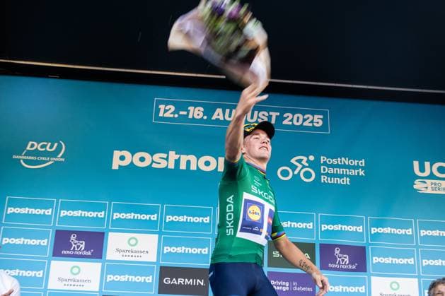August 13, 2025, Gladsaxe, Denmark: Mads Pedersen of Denmark and Lidl - Trek seen wearing the points jersey throws flowers from the podium after the 2 stage of PostNord Danmark Rundt 2025. The second stage of the PostNord Danmark Rundt 2025 cycling race starts in Rodovre and finishes in Gladsaxe. Gladsaxe Denmark - ZUMAs197 20250813_aaa_s197_085 Copyright: xKristianxTuxenxLadegaardxBergx