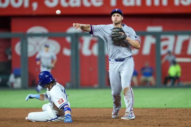 August 18, 2025: Texas Rangers shortstop Corey Seager (5) throws to first to complete the double play on Kansas City Royals shortstop Bobby Witt Jr. (7) at second and first baseman Vinnie Pasquantino (9) at first during the sixth inning of a baseball game at Kauffman Stadium in Kansas City, MO. CSM Kansas City United States of America - ZUMAc04_ 20250818_zma_c04_034 Copyright: xDavidxSmithx