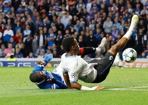 Rangers v Club Brugge UEFA Champions League Raphael Onyedika of Club Brugge is fouled by Mohamed Diomande of Rangers (left) during the UEFA Champions League Play-off First Leg match at Ibrox Stadium, Glasgow UK Newspapers OUT Copyright: xFredxPalmerx FIL-22118-0094