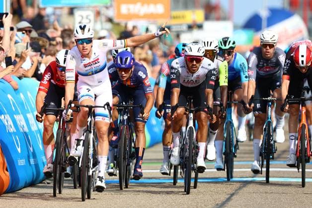 Belgian Tim Merlier of Soudal Quick-Step (2L) celebrates as he crosses the finish line to win, before Belgian Arnaud De Lie of Lotto Cycling Team (L) and Colombian Juan Sebastian Molano of UAE Team Emirates (C) the sprint at the finish of the first stage of the Renewi Tour multi-stage cycling race, from Terneuzen to Breskens, The Netherlands (182,7 km) on Wednesday 20 August 2025. The five-day race takes place in Belgium and the Netherlands. DAVIDxPINTENS  x131649346x