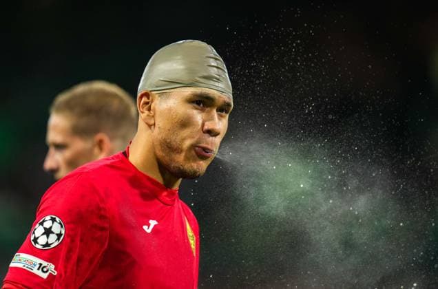 Kairat Almaty goalkeeper Temirlan Anarbekov spits water from his mouth while wearing a rubber cap after receiving treatment for a cut on his head caused in a clash with Shin Yamada of Celtic. Celtic v Kairat Almaty, UEFA Champions League, Play-Off Round, First Leg, Football, Celtic Park, Glasgow, Scotland, UK - 20 Aug 2025Glasgow Celtic Park Scotland United Kingdom EDITORIAL USE ONLY No use with unauthorised audio, video, data, fixture lists, club league logos or live services. Online in-match use limited to 120 images, no video emulation. No use in betting, games or single club league player publications.  Copyright: xStuartxWallace Shutterstockx 15446684ba