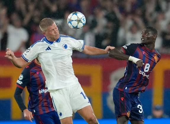 August 20, 2025, Basel, Switzerland: FC Copenhagen forward ANDREAS CORNELIUS (14) heads the ball as FC Basel 1893 midfielder JONAS ADJETEY (32) looks on during the UEFA Champions League Playoff match between FC Basel 1893 and FC Copenhagen on August 20, 2025, in Basel, Switzerland. The match finished a 1-1 draw. Basel Switzerland - ZUMAc201 20250820_zap_c201_030 Copyright: xScottxColemanx