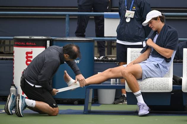Alexander Blockx of Belgium receives medical attention after suffering an ankle injuring during a tennis match between Belgian Blockx and Belgian Coppejans, in the second round of the qualifications for the men s signles of the 2025 US Open Grand Slam tennis tournament in New York City, USA, Thursday 21 August 2025. TONYxBEHAR  x131793844x