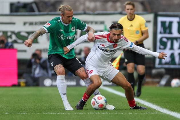 2 Bundesliga SC Preußen Münster 1 FC Nürnberg on 22 08 2025 at LVM Preußenstadion in Münster Berkay Yilmaz Nuernberg 21 vs Marvin Schulz Muenster 10 MH