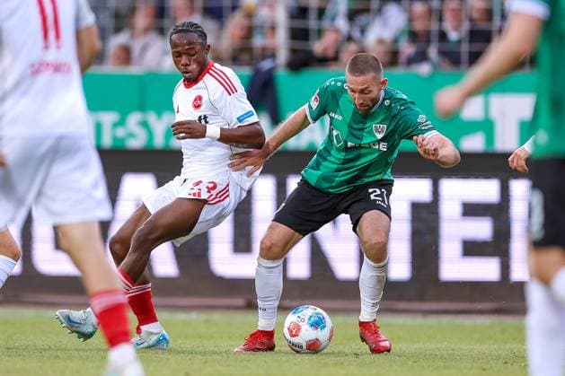 22 08 2025, Football, Preußen Münster 1 FC Nürnberg, 2 Fußball Bundesliga, Preußenstadion, Saison 2025 2026 Mohamed Alì Zoma 1FC Nuernberg 23 in duel against Rico Preißinger Preussen Muenster 21 DFB regulations prohibit any use of photographs as image sequences and or quasi video Nordrhein Westfalen Germany