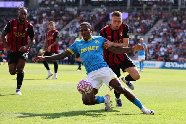 Football - 2025 2026 Premier League - AFC Bournemouth vs Wolverhampton Wanderers - The Vitality Stadium - Saturday 23rd August 2025 Adrien Truffert of Bournemouth holds off Jackson Tchatchoua of Wolverhampton during the Premier League match at the Vitality Stadium COLORSPORT Shaun Boggust 