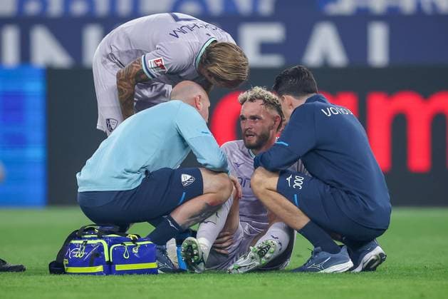 23 08 2025, Football, FC Schalke 04 VfL Bochum, Matchday 3, 2 Soccer Bundesliga, Veltins Arena Gelsenkirchen, Season 2025 2026 Philipp Strompf VfL Bochum 03 is injured on the pitch with pain and needs medical treatment Violation DFB regulations prohibit any use of photographs as image sequences and or quasi video North Rhine-Westphalia Germany