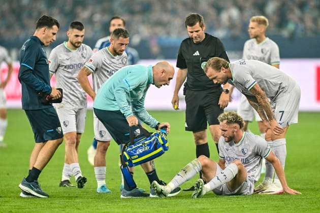 Philipp Strompf Bochum 3 injured on the ground Kevin Vogt bent over him and paramedics li 23 08 2025 Soccer FC Schalke 04 vs VfL Bochum, Veltins Arena, Gelsenkirchen, DFB DFL REGULATIONS PROHIBIT ANY USE OF PHOTOGRAPHS AS IMAGE SEQUENCES AND OR QUASI VIDEO Copyright: xpepphotox xSaschaxWeizx pep00321, pep_20250823_hm_111289