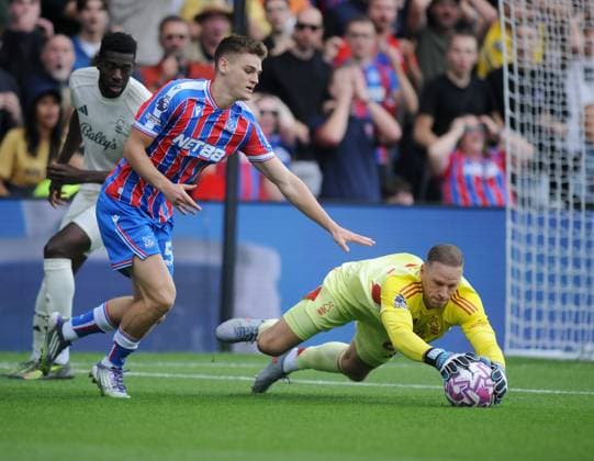 Football - 2025 2026 Premier League - Crystal Palace vs Nottingham Forest - Emirates Stadium - Sunday 24th August 2025 Matz Sels of Forest grabs the ball ahead of Justin Devenny of Crystal Palace 