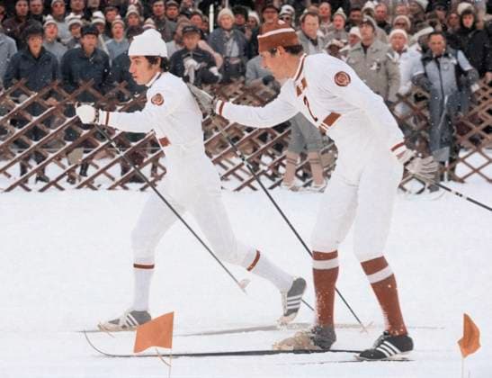 February, 1976. Innsbruck, Austria. Soviet athletes Yevgeny Belyaev (R), who damaged the ski mount on the first stage of the race, and Nikolai Bazhukov compete in the cross-country skiing 4x10km relay of the 1976 Winter Olympics. The Soviet team finishes in the 3rd place. AI-Colourised from original ID 32395389. Valery Zufarov, Vyacheslav Un Da-Sin TASS  82474703
