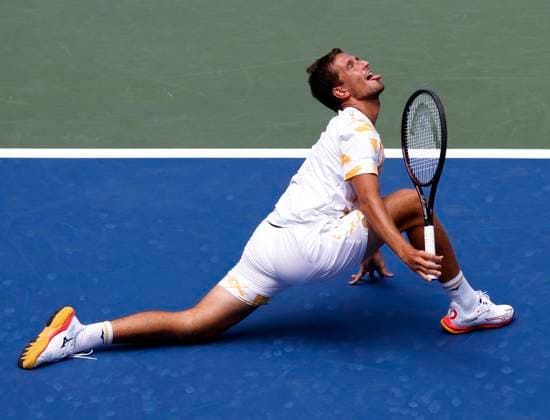 Vit Kopriva of Czechia reacts after stretching out to return a ball to Jannik Sinner of Italy in the first set of their first round match in Arthur Ashe Stadium on day 3 at the 2025 US Open Tennis Championship at the USTA Billie Jean King National Tennis Center in New York City on Tuesday, August 26, 2025.  NYP20250826128 JOHNxANGELILLO