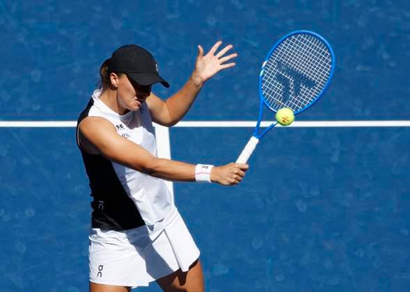 Iga Swiatek of Poland returns a ball to Emiliana Arango of Colombia in their first round match in Arthur Ashe Stadium on day 3 at the 2025 US Open Tennis Championship at the USTA Billie Jean King National Tennis Center in New York City on Tuesday, August 26, 2025. Swiatek defeated Arango in straight sets.  NYP20250826104 JOHNxANGELILLO
