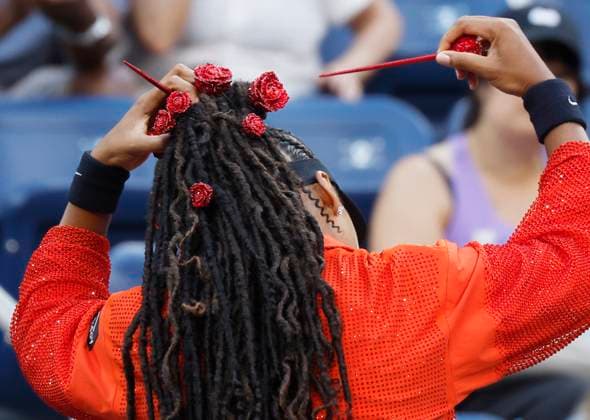 Naomi Osaka of Japan removes her flower decorated headdress before she warms up on the court in her first round match against Greet Minnen of Belgium in Louis Armstrong Stadium on day 3 at the 2025 US Open Tennis Championship at the USTA Billie Jean King National Tennis Center in New York City on Tuesday, August 26, 2025.  NYP20250826151 JOHNxANGELILLO