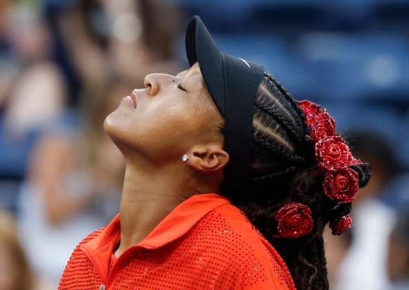 Naomi Osaka of Japan wears a flower decorated headdress before she warms up on the court in her first round match against Greet Minnen of Belgium in Louis Armstrong Stadium on day 3 at the 2025 US Open Tennis Championship at the USTA Billie Jean King National Tennis Center in New York City on Tuesday, August 26, 2025.  NYP20250826152 JOHNxANGELILLO