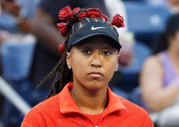 Naomi Osaka of Japan wears a flower decorated headdress before she warms up on the court in her first round match against Greet Minnen of Belgium in Louis Armstrong Stadium on day 3 at the 2025 US Open Tennis Championship at the USTA Billie Jean King National Tennis Center in New York City on Tuesday, August 26, 2025.  NYP20250826153 JOHNxANGELILLO