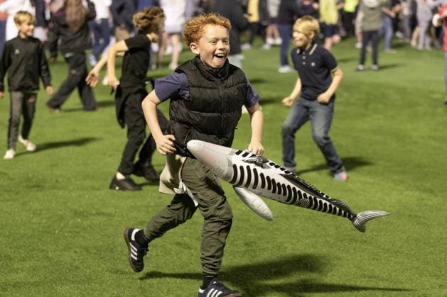 Grimsby Town FC v Manchester United, ManU EFL Cup 27 08 2025. Grimsby Town fan runs on to the pitch carrying a Harry The Haddock inflatable during the EFL Cup match between Grimsby Town FC and Manchester United at Blundell Park, Grimsby, United Kingdom on 27 August 2025. Editorial use only DataCo restrictions apply See www.football-dataco.com , Copyright: xJezxTighex PSI-22699-0132
