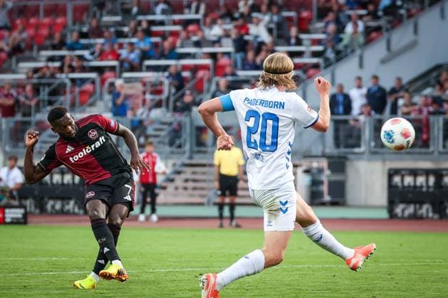 left to right Mickael Biron 7 1FC Nuernberg with a shot that Felix Goetze 20 SC Paderborn 07 cannot block, 1 FC Nuernberg vs SC Paderborn 07, DFL, 2 Bundesliga, Saison 2025 2026, Max Morlock Stadion, 4 Spieltag, Hinrunde, 29 08 2025 DFB regulations prohibit any use of photographs as image sequences and or quasi video Nuernberg Bayern Germany Copyright: xkolbert-press MartinxAgüerax