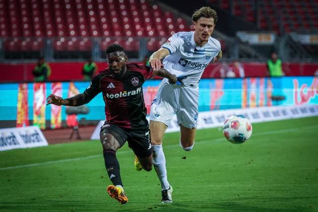 left to right Mickael Biron 7 1FC Nuernberg and Calvin Brackelmann 4 SC Paderborn 07 in a duel, 1 FC Nuernberg vs SC Paderborn 07, DFL, 2 Bundesliga, Saison 2025 2026, Max Morlock Stadion, 4 Spieltag, Hinrunde, 29 08 2025 DFB regulations prohibit any use of photographs as image sequences and or quasi video Nuernberg Bayern Germany Copyright: xkolbert-press MartinxAgüerax