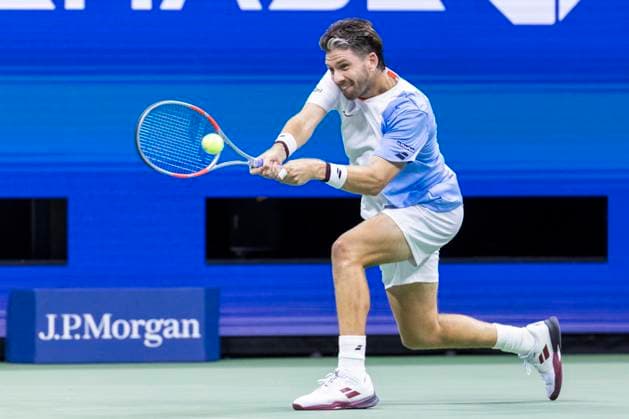 Cameron Norrie of Great Britain returns a ball to Novak Djokovic of Serbia in the third round in Arthur Ashe Stadium on day 6 at the 2025 US Open Tennis Championship at the USTA Billie Jean King National Tennis Center in New York City on Friday, August 29, 2025.  NYP20250829813 COREYxSIPKIN