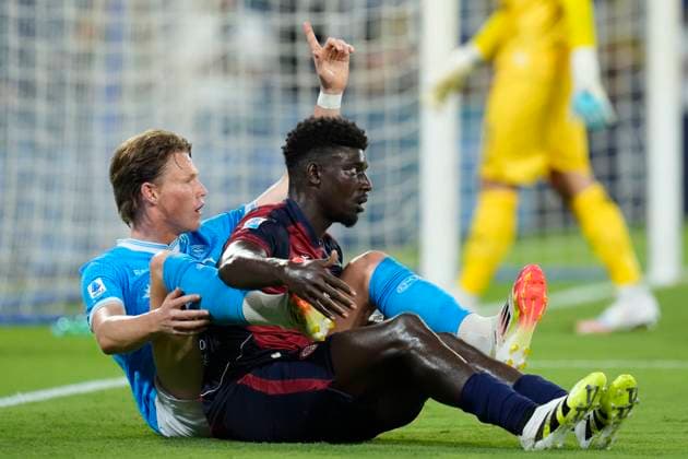 Scott McTominay (SSC Napoli) and Michel Adopo (Cagliari Calcio) lie on the ground, Serie A, SSC Napoli v Cagliari Calcio, Diego Maradona Stadium, August 30, 2025, Naples, Italy.
