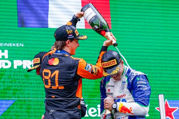 podium ceremony, Isack Hadjar of France and Visa Cash App Racing Bulls gets a champagne shower from Oscar Piastri of Australia and McLaren F1 Team during the Formula 1 Heineken Dutch Grand Prix 2025 on Day 3 at Circuit Zandvoort on August 31, 2025 in Zandvoort, Netherlands Photo by Marcel ter Bals DeFodi Images