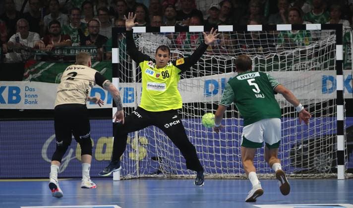 Noah Beyer scores a goal against goalkeeper Dejan Milosavljev duel Match scene Action Sport Handball HBL Bundesliga Men 1 Matchday Season 2025 2026 31 08 2025 Füchse Berlin vs Bergischer HC