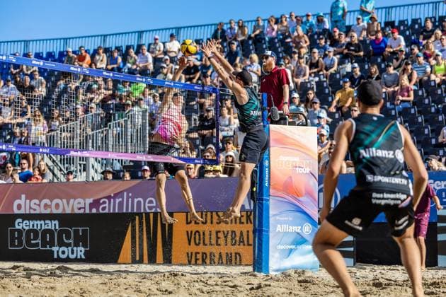 Beach Volleyball I German Championships 2025 I Timmendorfer Strand I Day 3 I 06 09 2025 Attack Jonas Reinhardt Beach Verein Mainz e V against the block of Lukas Pfretzschner Eintracht Spontent Timmendorfer Strand Schleswig Holstein Germany Copyright: xLobeca JasperxLorenzx