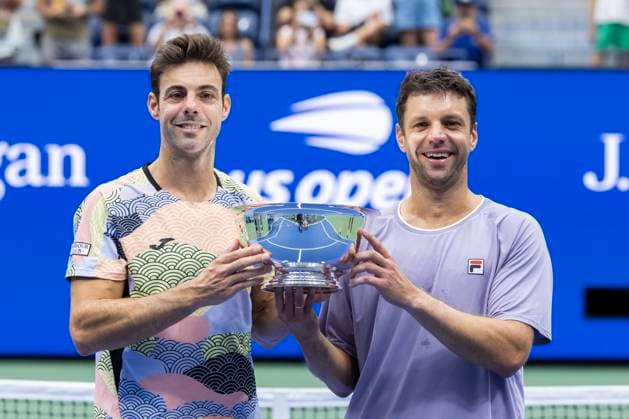 Marcel Granollers of Spain (L) and Horacio Zeballos of Argentina hold their trophy after beating Joe Salisbury and Neal Skupski, both of Great Britain, in the Men s Doubles final at the 2025 US Open Tennis Championship at the USTA Billie Jean King National Tennis Center in New York City on Saturday, September 6, 2025. Granollers and Zeballos won 3-6, 7-4, 7-5.  NYP20250906801 COREYxSIPKIN
