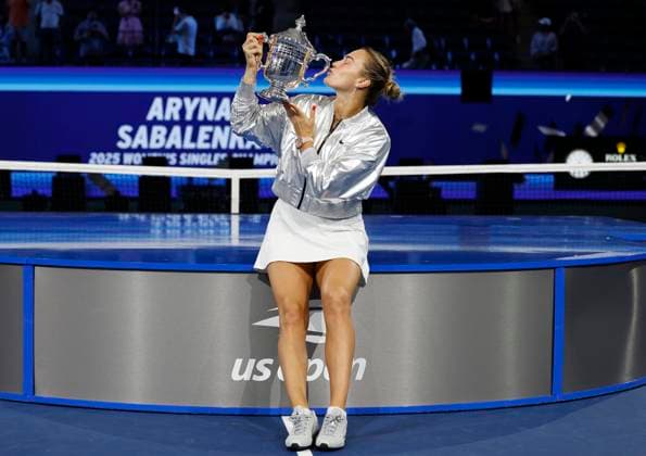 Aryna Sabalenka of Belarus kisses her trophy after defeating Amanda Anisimova at the Women s Finals of the 2025 US Open Tennis Championship in Arthur Ashe Stadium at the USTA Billie Jean King National Tennis Center in Flushing Meadows, New York on Saturday, September 6, 2025. Sabalenka defeated Anisimova 6-3, 7-6 to win her second consecutive US Open Championship.  NYP20250906140 JOHNxANGELILLO