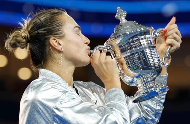 Aryna Sabalenka of Belarus kisses her trophy after defeating Amanda Anisimova at the Women s Finals of the 2025 US Open Tennis Championship in Arthur Ashe Stadium at the USTA Billie Jean King National Tennis Center in Flushing Meadows, New York on Saturday, September 6, 2025. Sabalenka defeated Anisimova 6-3, 7-6 to win her second consecutive US Open Championship.  NYP20250906141 JOHNxANGELILLO