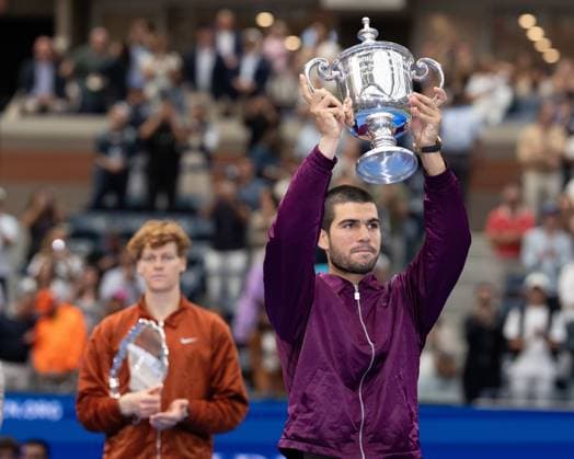 Winner Carlos Alcaraz ESP with the trophy, trophy, finalist Jannik Sinner ITA in the background, Mens Singles, award ceremony, Presentationl, US Open Championships 2025, USTA Billie Jean King National Tennis Center, Flushing Meadows, New York, USA Copyright: xJuergenxHasenkopfx
