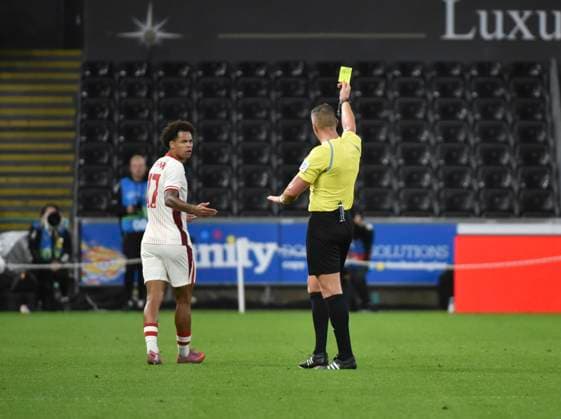 9th September 2025; Swansea.com Stadium, Swansea, Wales; Friendly International Football, Wales versus Canada; Tajon Buchanan of Canada receives a yellow card from the referee, Robert Jones for dissent  AledxHopkins