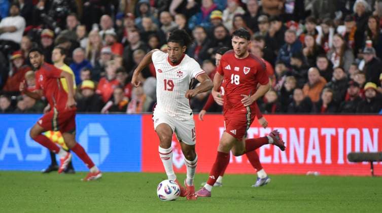 9th September 2025; Swansea.com Stadium, Swansea, Wales; Friendly International Football, Wales versus Canada; Nathan-Dylan Saliba of Canada on the ball breaks from Mark Harris of Wales  AledxHopkins