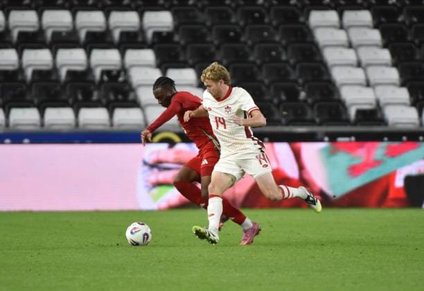 9th September 2025; Swansea.com Stadium, Swansea, Wales; Friendly International Football, Wales versus Canada; Jacob Shaffelburg of Canada tackles Ronan Kpakio of Wales  AledxHopkins