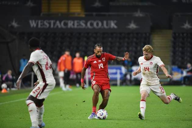 9th September 2025; Swansea.com Stadium, Swansea, Wales; Friendly International Football, Wales versus Canada; Kai Andrews of Wales controls the ball and is pressured by Jacob Shaffelburg and Richie Laryea of Canada  AledxHopkins