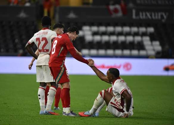 9th September 2025; Swansea.com Stadium, Swansea, Wales; Friendly International Football, Wales versus Canada; Harry Wilson of Wales helps Derek Cornelius of Canada off the pitch  AledxHopkins