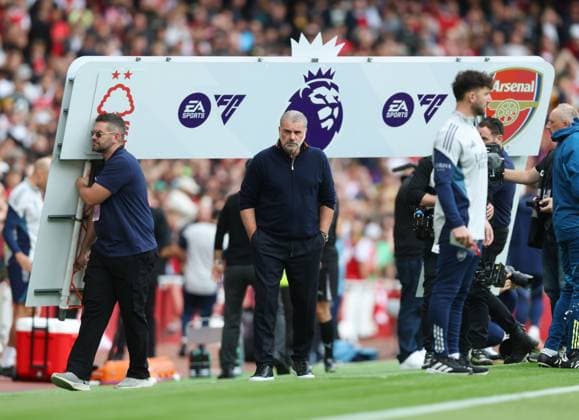 London, England, 13th September 2025. Ange Postecoglou manager of Nottingham Forest stands as they remove the Premier League sign during the Arsenal vs Nottingham Forest Premier League match at the Emirates Stadium, London. Picture credit should read: David Klein Sportimage EDITORIAL USE ONLY. No use with unauthorised audio, video, data, fixture lists, club league logos or live services. Online in-match use limited to 120 images, no video emulation. No use in betting, games or single club league player publications. SPI_003_DK_Arsenal_Forest SPI-4131-0003