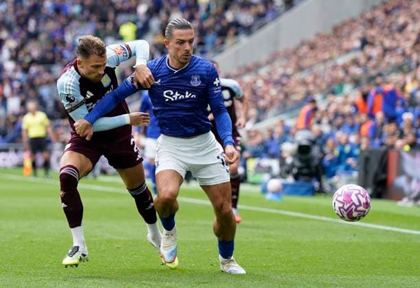 Liverpool, England, 13th September 2025. Jack Grealish of Everton (R) is challenged by Matty Cash of Aston Villa during the Everton vs Aston Villa Premier League match at Hill Dickinson Stadium, Liverpool. Picture credit should read: Andrew Yates Sportimage EDITORIAL USE ONLY. No use with unauthorised audio, video, data, fixture lists, club league logos or live services. Online in-match use limited to 120 images, no video emulation. No use in betting, games or single club league player publications. SPI_010_AY_EVERTON_VILLA SPI-4134-0009