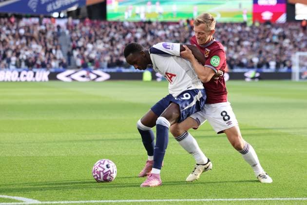 London, England, 13th September 2025. Pape Matar Sarr of Tottenham Hotspur and James Ward-Prowse of West Ham challenge for the ball during the West Ham United vs Tottenham Hotspur Premier League match at the London Stadium, London. Picture credit should read: Paul Terry Sportimage EDITORIAL USE ONLY. No use with unauthorised audio, video, data, fixture lists, club league logos or live services. Online in-match use limited to 120 images, no video emulation. No use in betting, games or single club league player publications. SPI_008_PT_West_Ham_Tottenham SPI-4133-0008