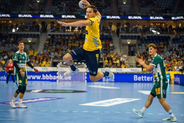 Robert Timmermeister 7 Rhein Neckar Löwen jumps to throw while Stephan Seitz 44 ThSV Eisenach and Philipp Meyer 27 ThSV Eisenach defend Robert Timmermeister 7 Rhein Neckar Löwen throws on goal Copyright: xspeedshotx xLukasxTrunkx