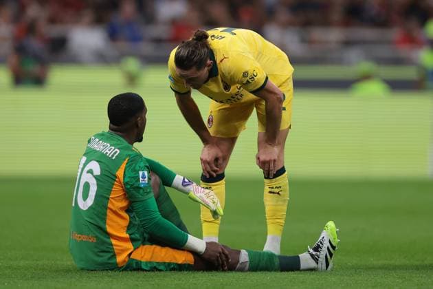 Milan, Italy, 14th September 2025. Adrien Rabiot of AC Milan checks on team mate Mike Maignan after he pulled up with an injury during the AC Milan vs Bologna Serie A match at Giuseppe Meazza, Milan. Picture credit should read: Jonathan Moscrop Sportimage EDITORIAL USE ONLY. No use with unauthorised audio, video, data, fixture lists, club league logos or live services. Online in-match use limited to 120 images, no video emulation. No use in betting, games or single club league player publications. SPI_022_JM_MILAN_BOLOGNA_ SPI-4120-0022