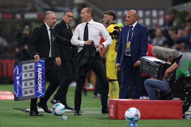 Milan, Italy, 14th September 2025. Massimiliano Allegri Head coach of AC Milan reacts with the Fourth Official Antonio Rapuano after being shown a red card by the Referee Matteo Marcenaro during the AC Milan vs Bologna Serie A match at Giuseppe Meazza, Milan. Picture credit should read: Jonathan Moscrop Sportimage EDITORIAL USE ONLY. No use with unauthorised audio, video, data, fixture lists, club league logos or live services. Online in-match use limited to 120 images, no video emulation. No use in betting, games or single club league player publications. SPI_033_JM_MILAN_BOLOGNA_ SPI-4120-0033