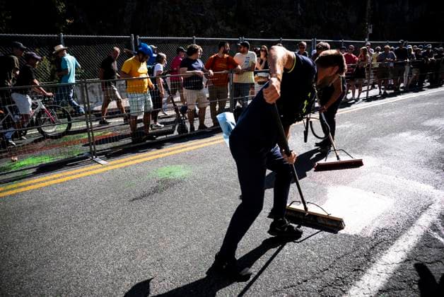September 14, 2025, Montreal, Qc, Canada: Race crew clean up green and red paint thrown on the race course by activists protesting the participation of Israel Premier Tech racing team during the the UCI Montreal Grand Prix Cycling race action in Montreal on Sunday, Sept. 14, 2025. Canada News - September 14, 2025  - ZUMAc35_ 20250914_zaf_c35_108 Copyright: xChristopherxKatsarovx
