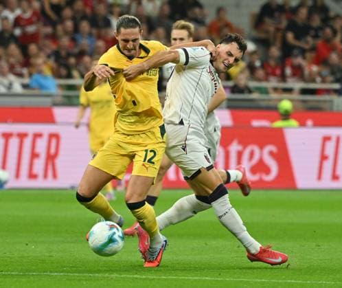 (250915) -- MILAN, Sept. 15, 2025 -- AC Milan s Adrien Rabiot (L) vies with Bologna s Nadir Zortea during a Serie A football match between AC Milan and Bologna in Milan, Italy, Sept. 14, 2025. (Photo by Xinhua) (SP)ITALY-MILAN-FOOTBALL-SERIE A-AC MILAN VS BOLOGNA AlbertoxLingria 