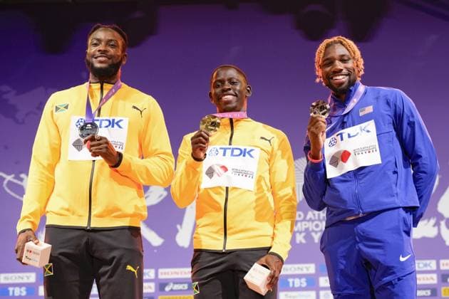 Athletics: World championships in Tokyo Gold medalist Oblique Seville (C) of Jamaica poses on the podium during the medal ceremony for the men s 100-meter event at the World Athletics Championships at the National Stadium in Tokyo on Sept. 15, 2025, with his compatriot and silver medalist Kishane Thompson (L) and bronze medalist Noah Lyles of the United States.  A14AA0004851371P
