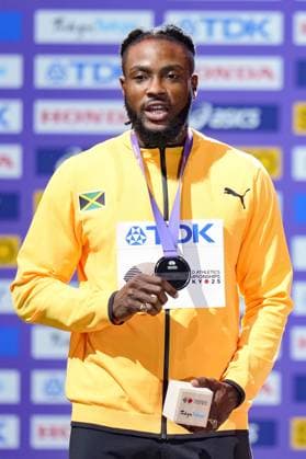 Athletics: World championships in Tokyo Silver medalist Kishane Thompson of Jamaica poses on the podium during the medal ceremony for the men s 100-meter event at the World Athletics Championships at the National Stadium in Tokyo on Sept. 15, 2025.  A14AA0004851374P